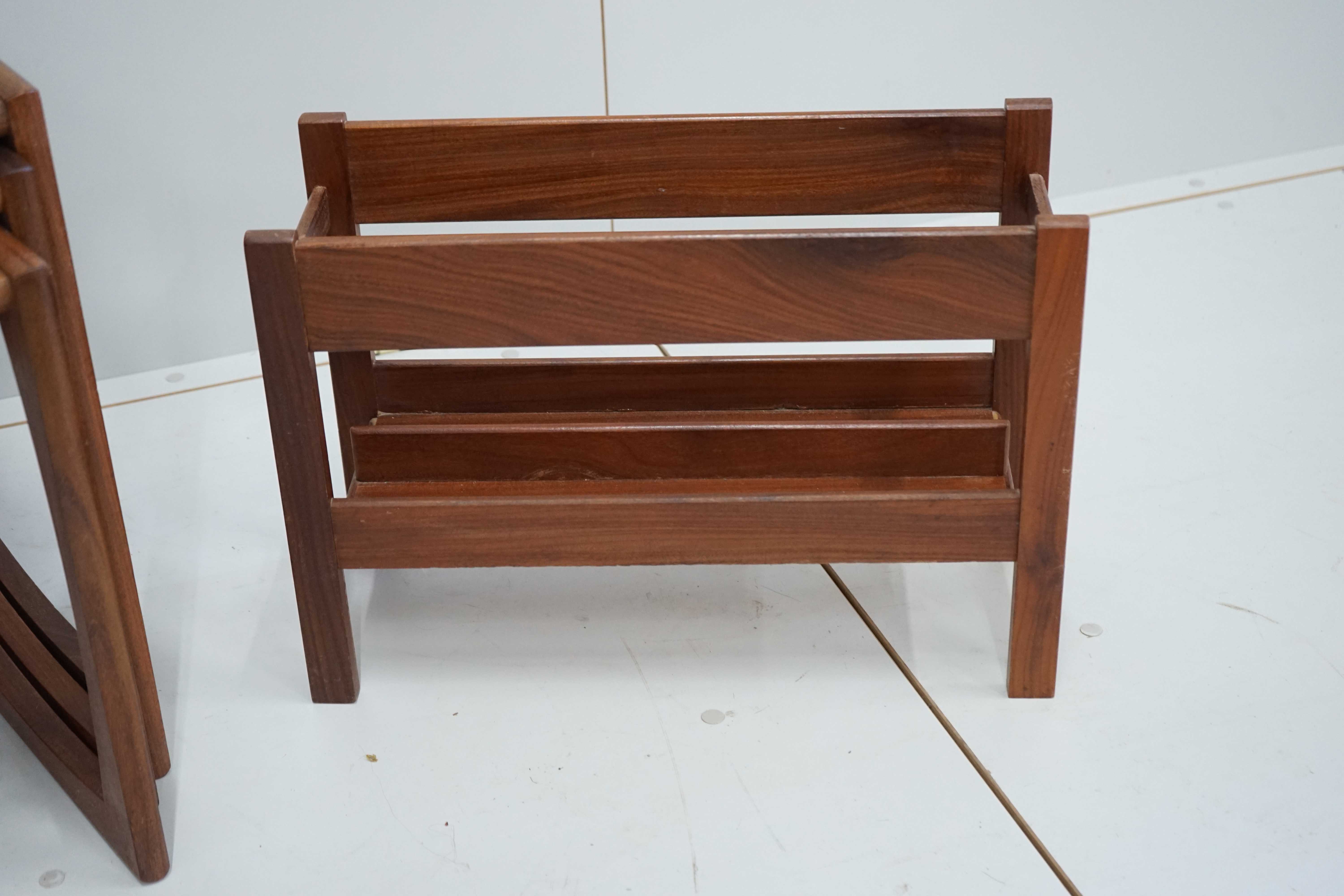 A nest of three G Plan teak tables, width 53cm, depth 43cm, height 49cm together with a two division Canterbury